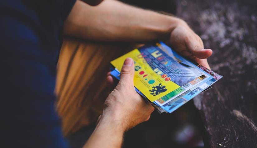 Man-reading-flyers-in-mail
